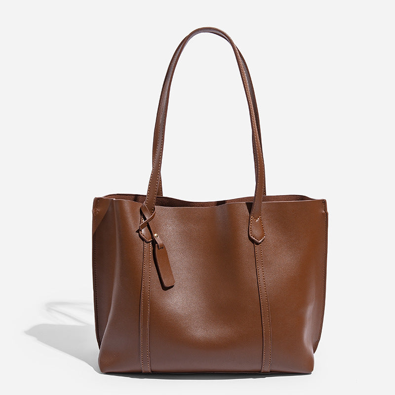 Large structured leather-look tote bag with belt-strap detail and gold-tone hardware, detail view 8