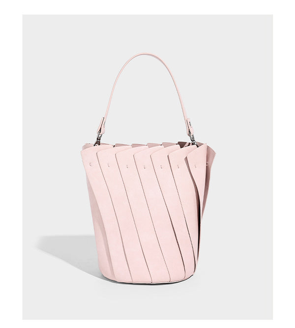 Structured pleated-panel bucket bag with curved top handle and detachable adjustable shoulder strap in smooth matte, detail
