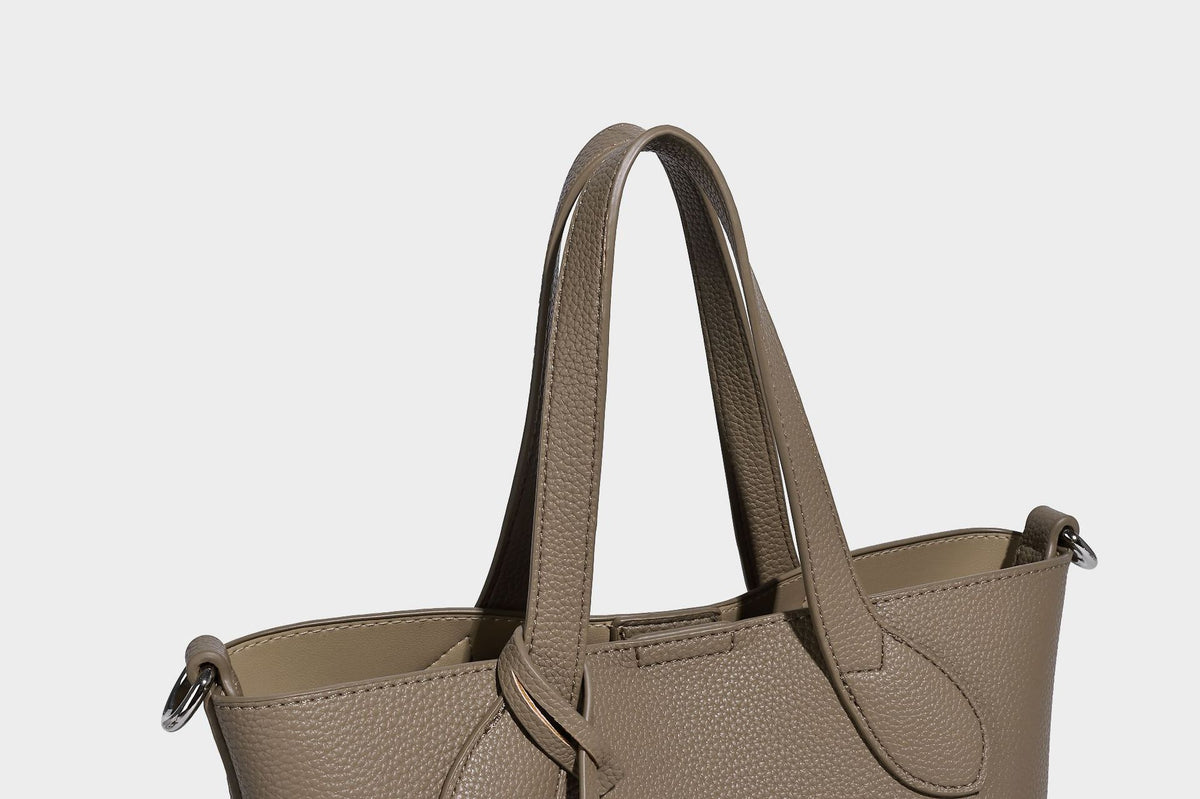Compact pebbled bucket tote bag with elephant charm, twin top handles, and detachable crossbody strap, detail view 17