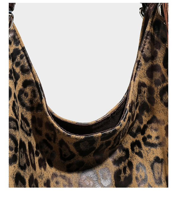 Slouchy leopard-print shoulder tote bag in tan and brown with long double straps, side tie straps, and dangling charm, detail