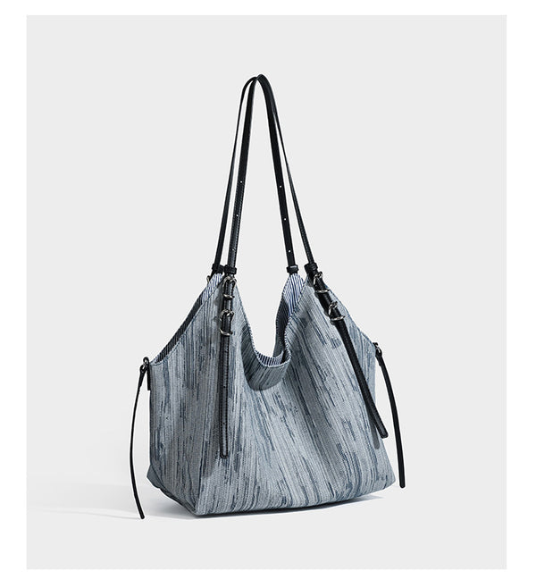 Large slouchy woven-texture shoulder tote bag with slim leather-look straps, side cinch ties, and silver-tone hardware