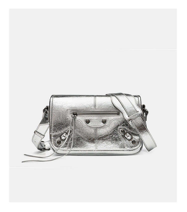 Small structured rectangular crossbody bag with crinkle leather-look finish, front zip pocket, gunmetal stud hardware, and