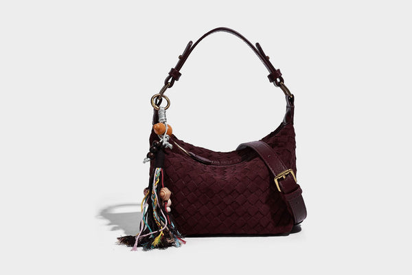 Small woven-texture crescent hobo bag in dark chocolate brown with top zip closure, gold-tone hardware, and adjustable