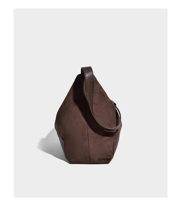 Dark brown slouchy hobo bag with matte suede-look body, smooth leather-look base trim, adjustable shoulder strap, and, detail