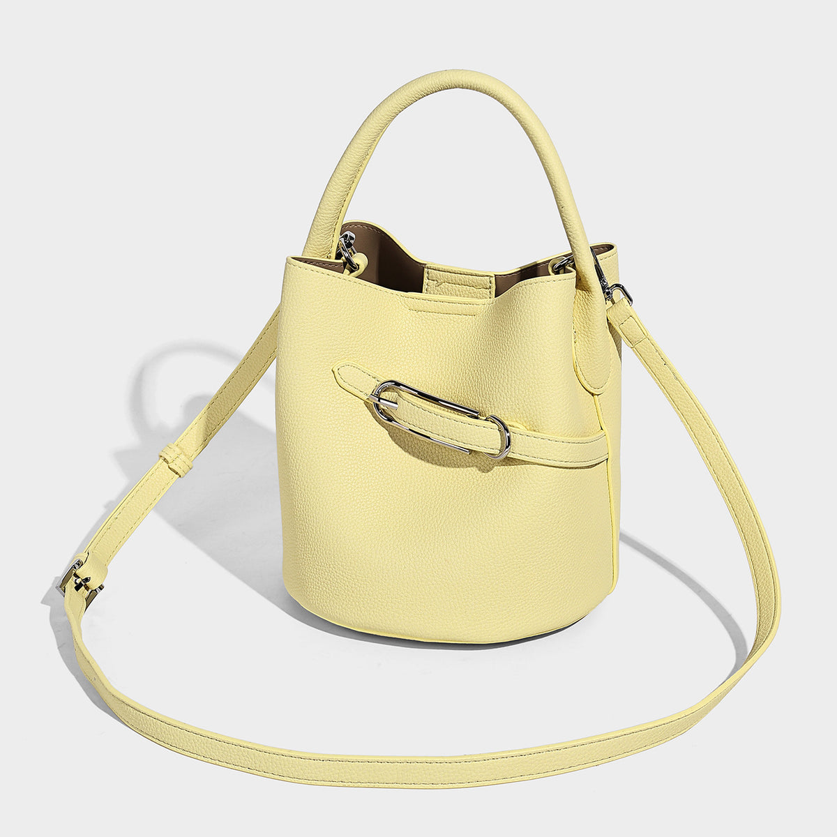 Mini pebbled leather-look bucket bag with front buckle strap, silver-tone hardware, top handle, and detachable shoulder