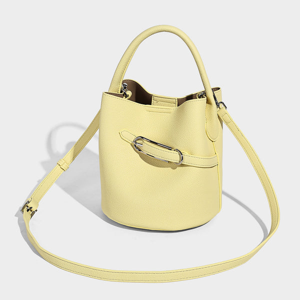 Mini pebbled leather-look bucket bag with front buckle strap, silver-tone hardware, top handle, and detachable shoulder
