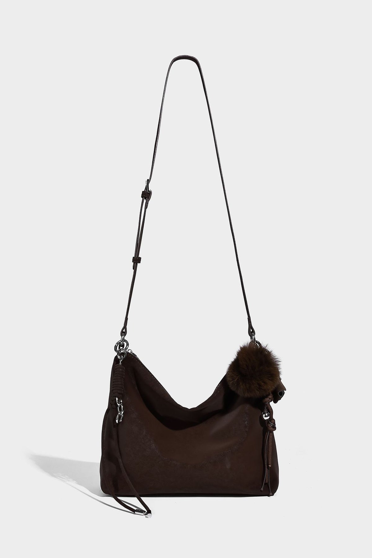 Slouchy matte-finish hobo shoulder bag with tassel cords, silver-tone hardware, and faux-fur pom charm, detail view 18