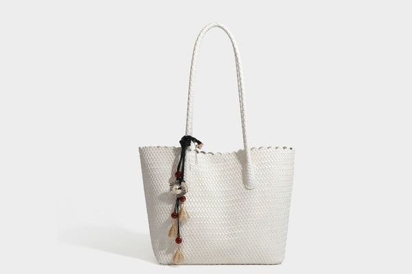 Large open-top woven leather-look tote bag in dark brown with scalloped edge, braided double shoulder straps, and decorative