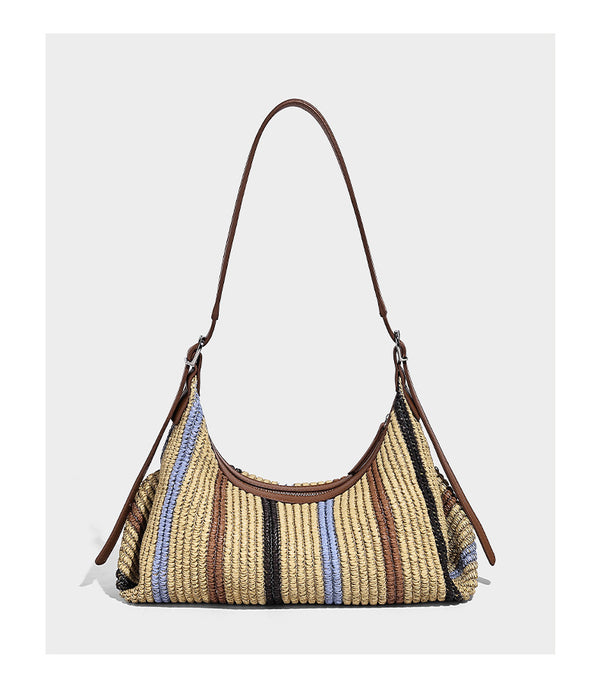 Slouchy woven straw hobo shoulder bag with beige, black, brown, and blue vertical stripes and brown leather-look trim, detail