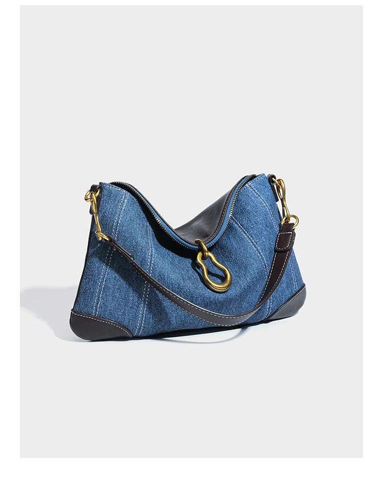 Slouchy denim shoulder bag with dark leather-look trim, gold-tone chain-link hardware, and top zipper closure, detail view 7