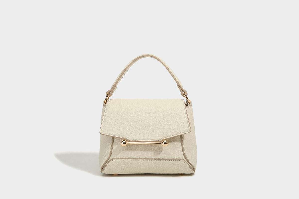 Small structured pebbled flap mini satchel with gold-tone bar hardware, short top handle, and detachable crossbody strap