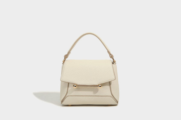 Small structured pebbled flap mini satchel with gold-tone bar hardware, short top handle, and detachable crossbody strap