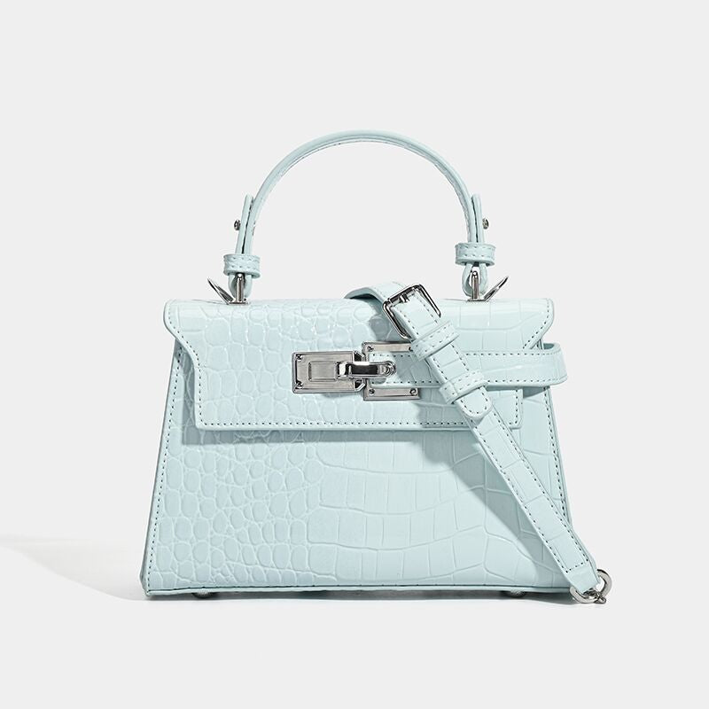 Croc-embossed mini top-handle satchel with silver turn-lock closure and adjustable crossbody strap, detail view 8