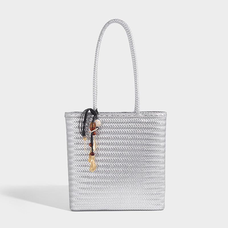Structured woven herringbone tote bag with braided double shoulder handles in tan brown, shown with matching drawstring