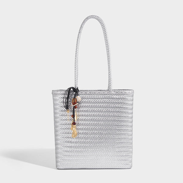 Structured woven herringbone tote bag with braided double shoulder handles in tan brown, shown with matching drawstring