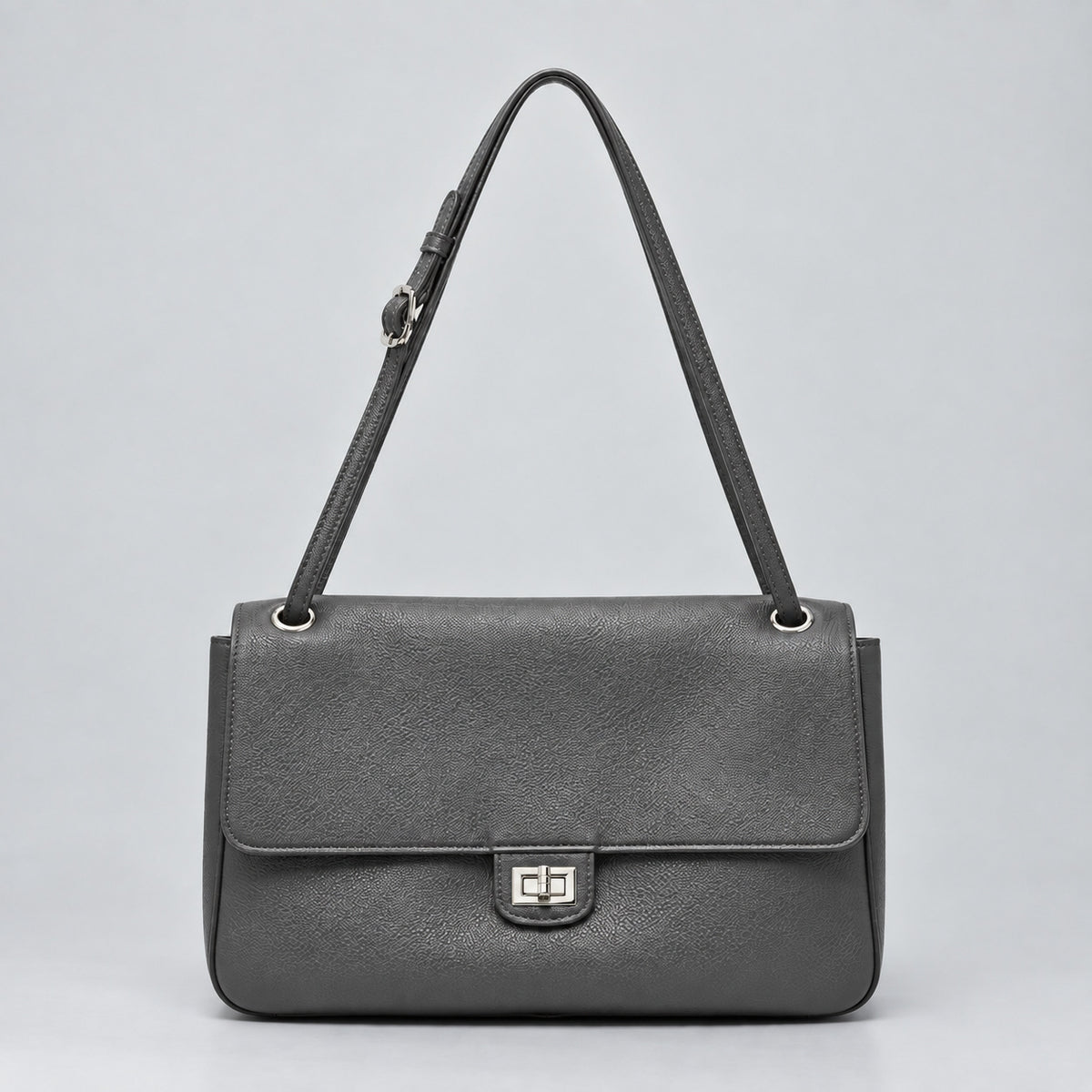 Structured black flap shoulder bag with pebbled texture, silver-tone turn-lock closure, and adjustable single shoulder strap