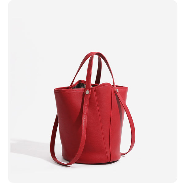 Large leather-look bucket tote bag with dual top handles and adjustable crossbody strap, detail view 12