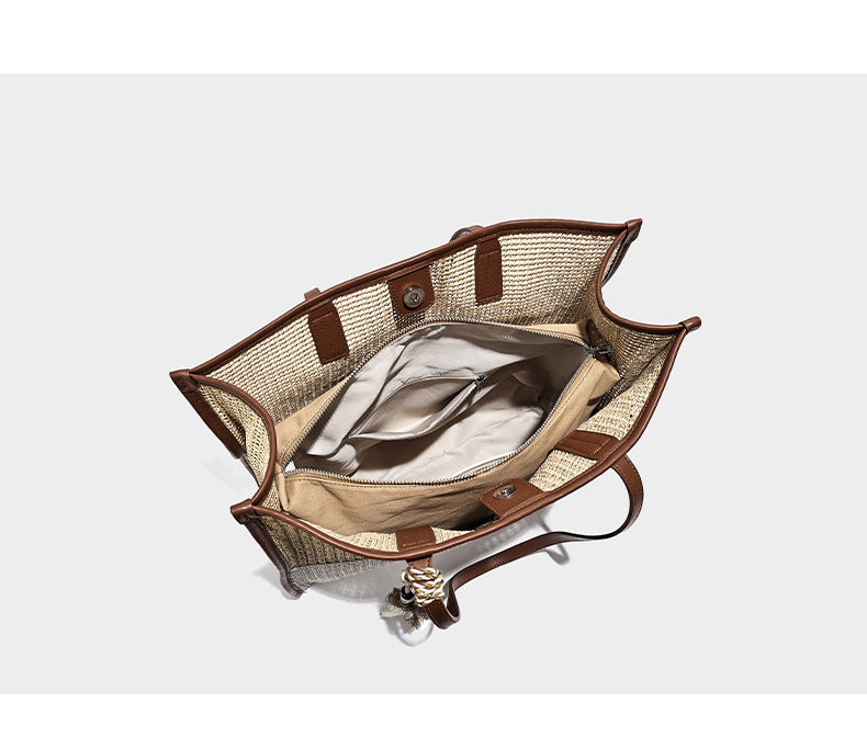 Two-tone woven straw tote bag with leather-look brown trim, long shoulder straps, and knotted tassel charm, detail view 7
