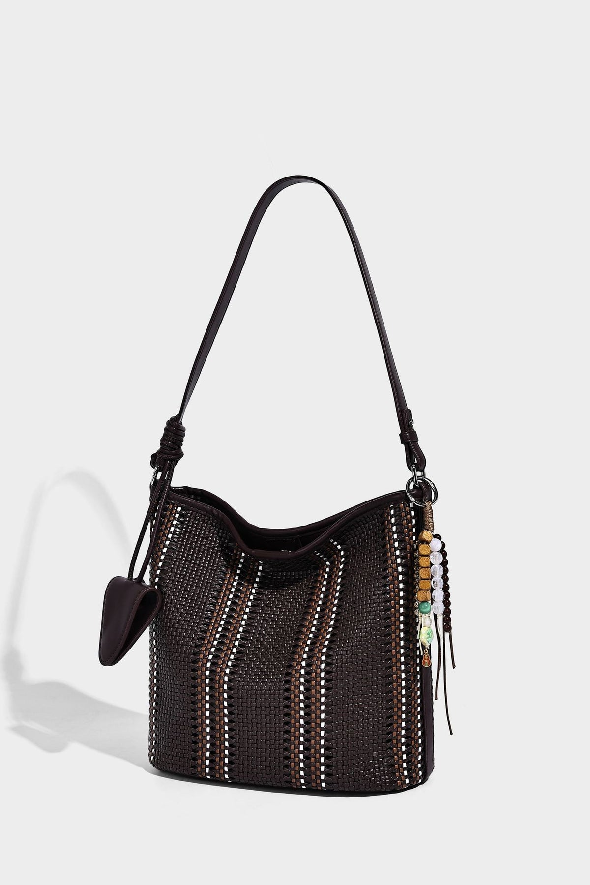 Woven bucket shoulder bag with leather-look trim, silver-tone hardware, and beaded tassel charm, detail view 19