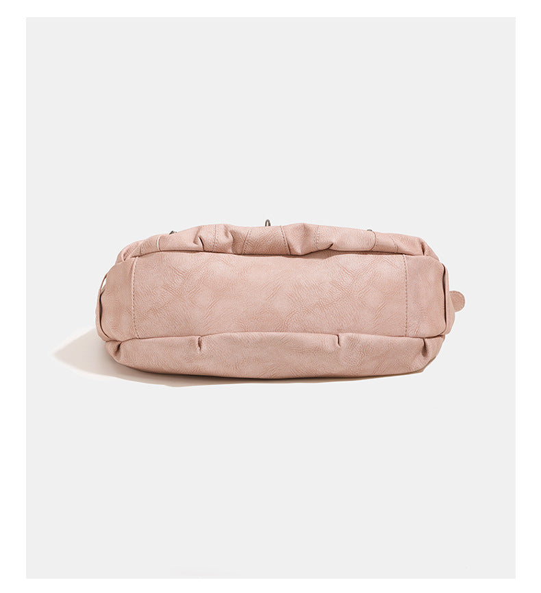 Crescent hobo shoulder bag in matte leather-look finish with star stud front panel, antique-silver hook hardware, and, detail