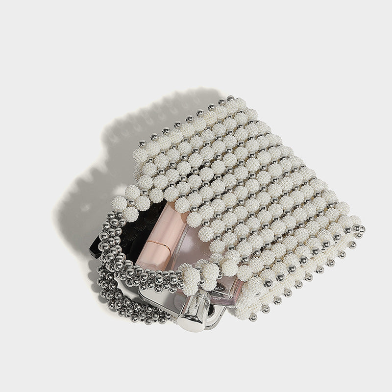 Small boxy pearl-bead mini top-handle bag with silver metallic bead accents, satin floral detail, and long beaded shoulder