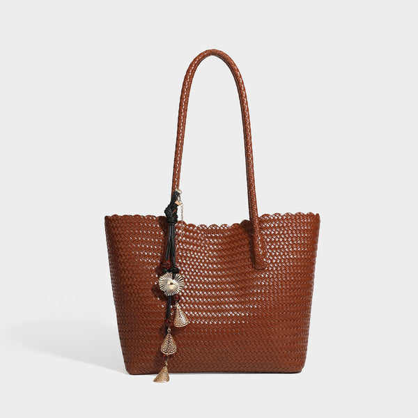Large open-top woven leather-look tote bag in dark brown with scalloped edge, braided double shoulder straps, and decorative