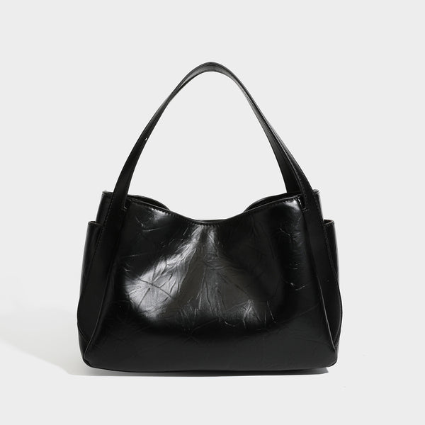 Black glossy crinkled leather-look convertible shoulder tote bag with gold gourd-shaped emblem hardware and detachable