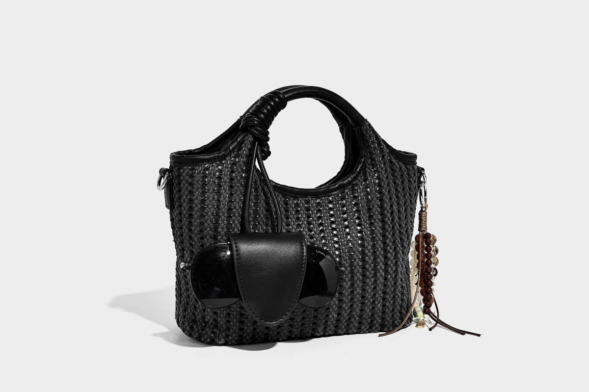 Small structured woven tote crossbody bag with ring top handle, leather-look brown trim, front patch pocket, and detachable