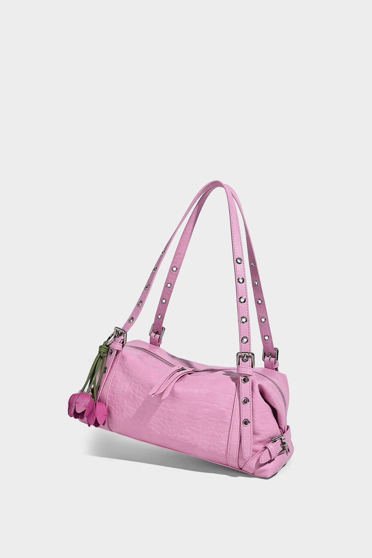 Pale yellow leather-look barrel bag with silver grommet-studded shoulder straps, top zip closure, and pink tulip floral