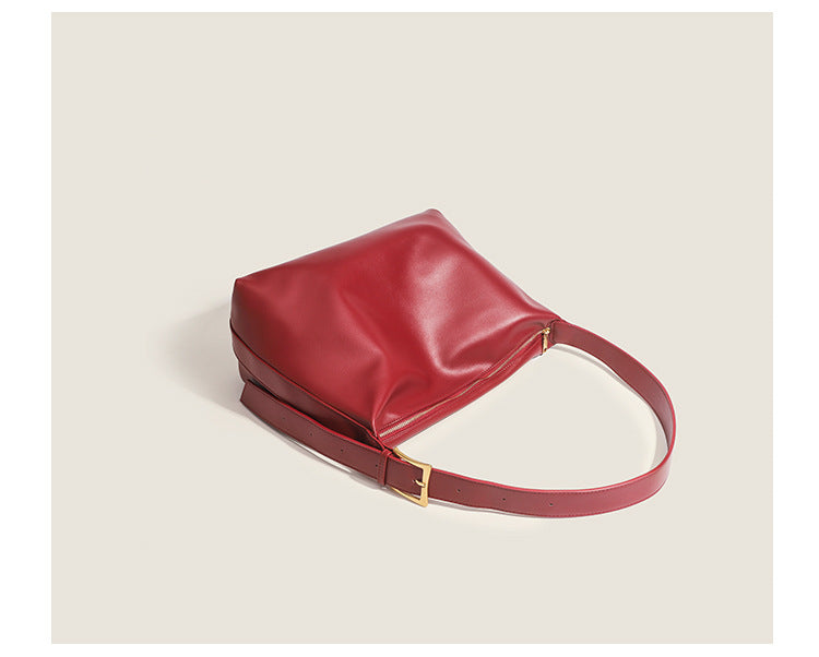 Large slouchy hobo shoulder bag in smooth leather-look finish with single long strap and gold-tone zip closure, detail view
