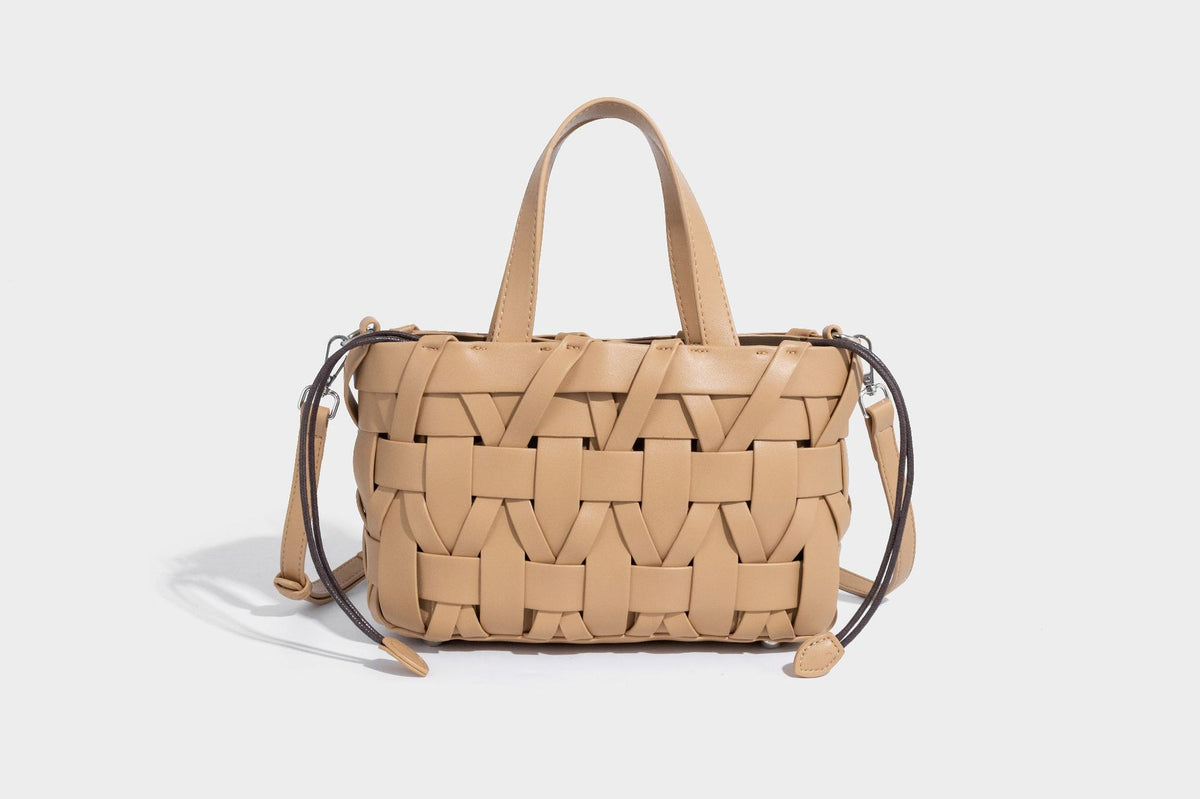 Structured woven basket tote handbag with contrasting dark trim, double top handles, detachable shoulder strap, and