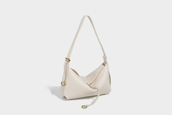 Slouchy brown leather-look shoulder bag with knotted drawcord tie closure, gold-tone ring hardware, and long adjustable