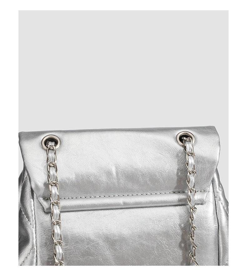 Quilted leather-look backpack with heart turn-lock clasp and woven chain handles, detail view 10