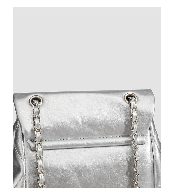 Quilted leather-look backpack with heart turn-lock clasp and woven chain handles, detail view 10