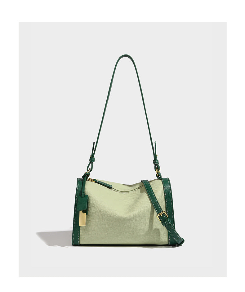 Structured two-tone shoulder bag with pebbled leather-look finish, contrast trim, top zip closure, and gold-tone hardware