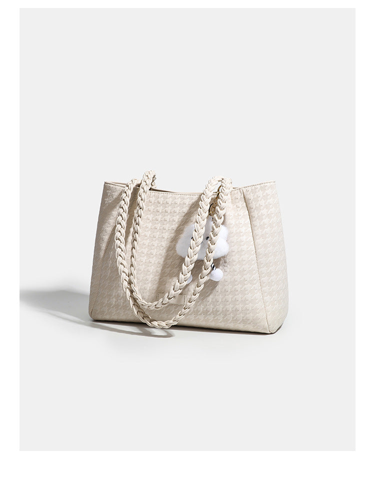 Structured geometric-embossed tote bag with braided shoulder straps and gold-tone hardware in ivory, detail view 8