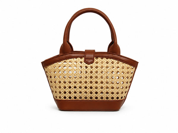 Structured mini tote bag with open-weave rattan body, leather-look arched handles and trim, front tab turn-lock closure, and