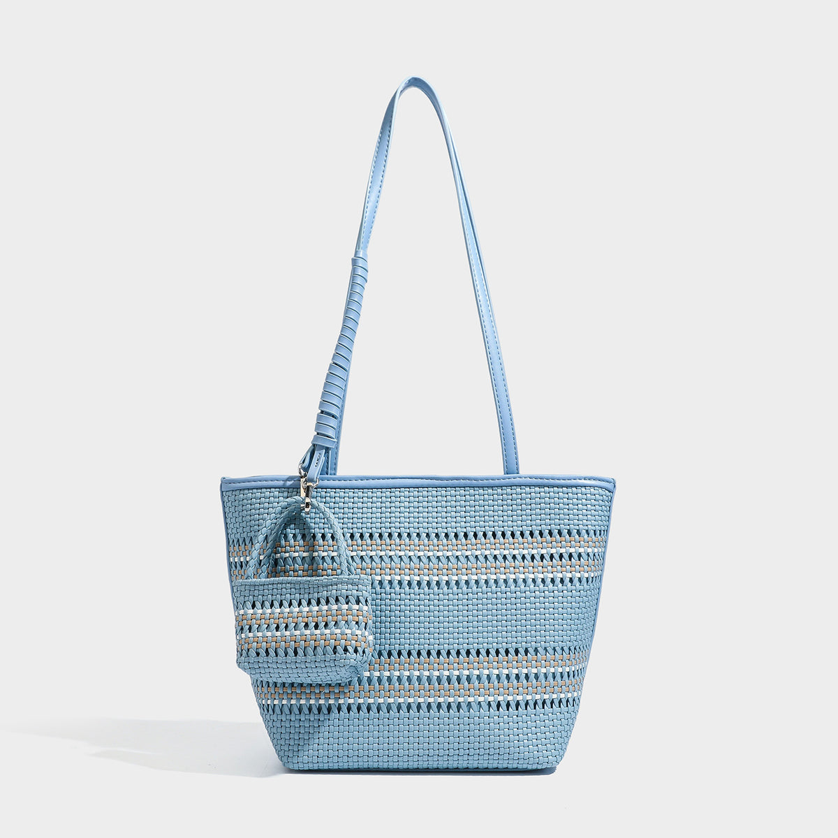 Large structured woven tote bag with striped basket-weave finish, long shoulder straps, and detachable mini pouch charm