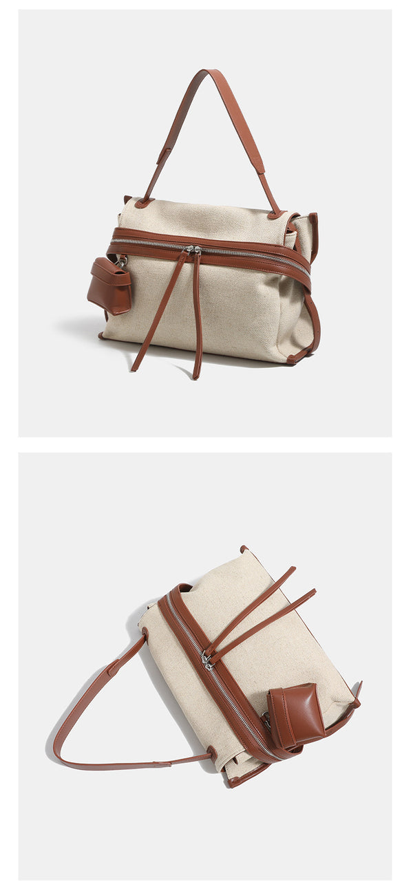 Off-white woven cotton-linen shoulder bag with brown leather-look trim, dual zip closure, long zipper pulls, front exterior