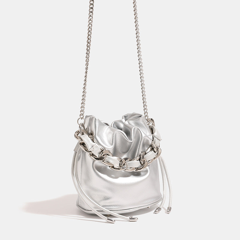 Small ruched drawstring bucket bag with chunky woven chain top handle and fine-link crossbody strap, front view
