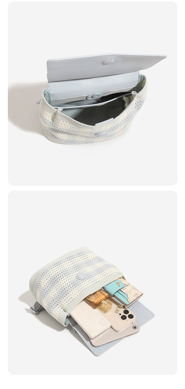 Small structured woven-body flap bag with smooth leather-look front panel, knotted top handle, and wide adjustable shoulder