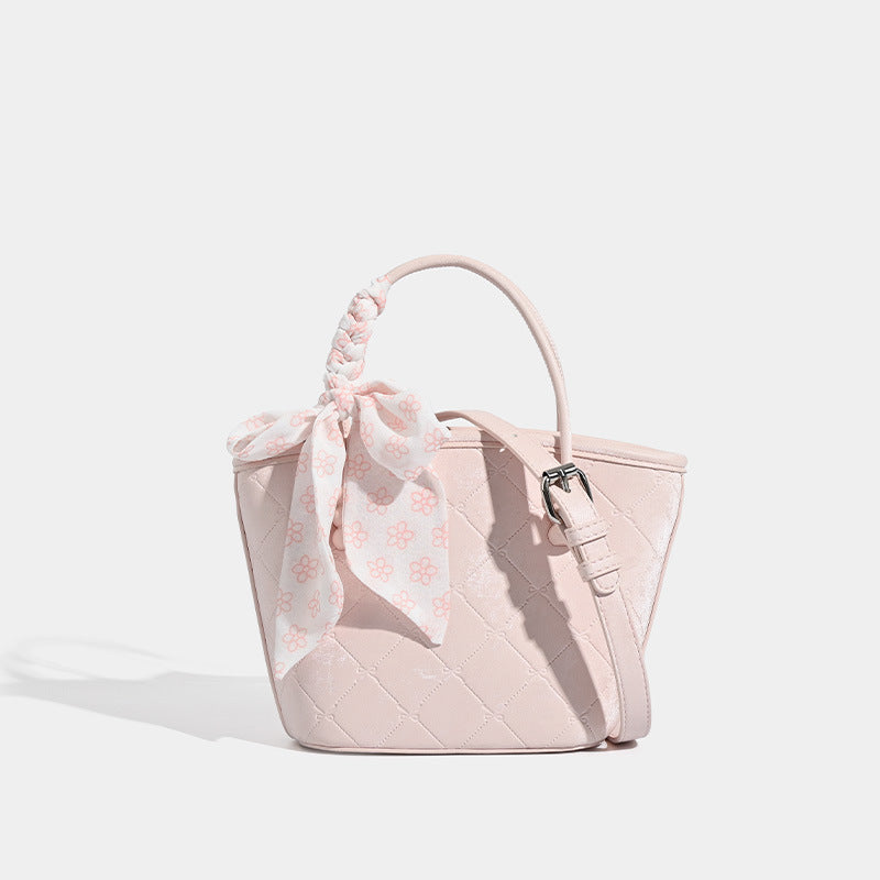 Quilted leather-look mini tote bag with printed scarf bow on braided top handle and silver-tone hardware, detail view 6
