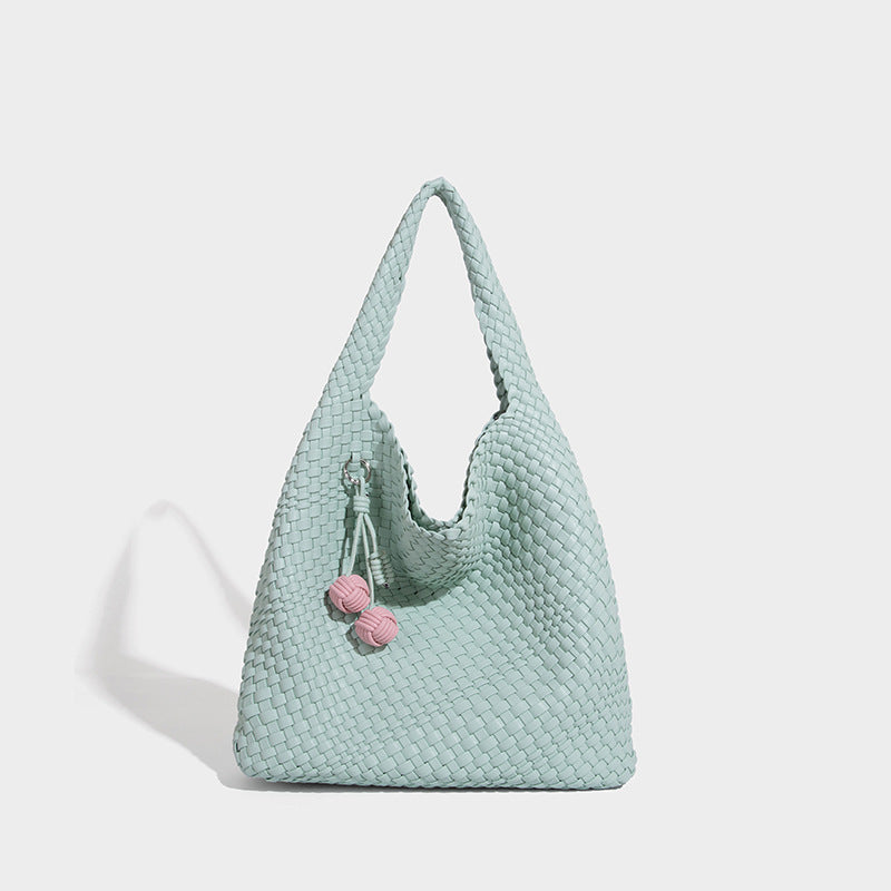 Soft hand-woven slouchy hobo tote bag with knotted tassel charm and single looped shoulder strap, detail view 9