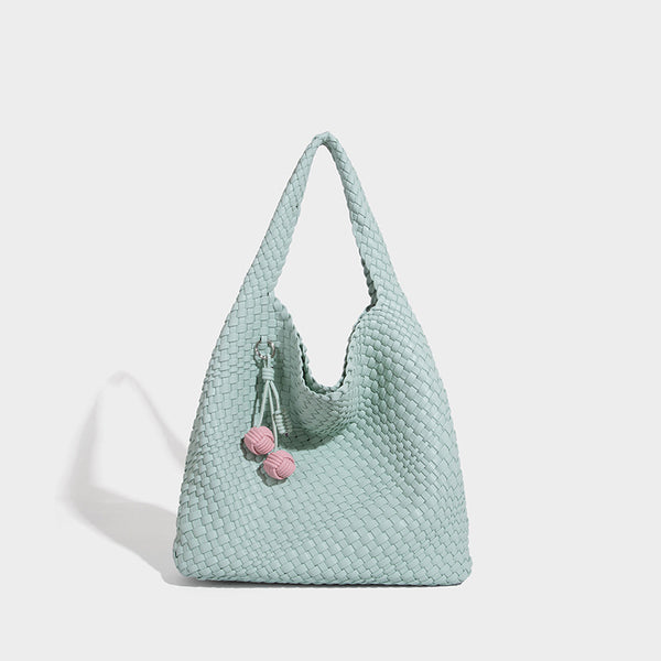 Soft hand-woven slouchy hobo tote bag with knotted tassel charm and single looped shoulder strap, detail view 9