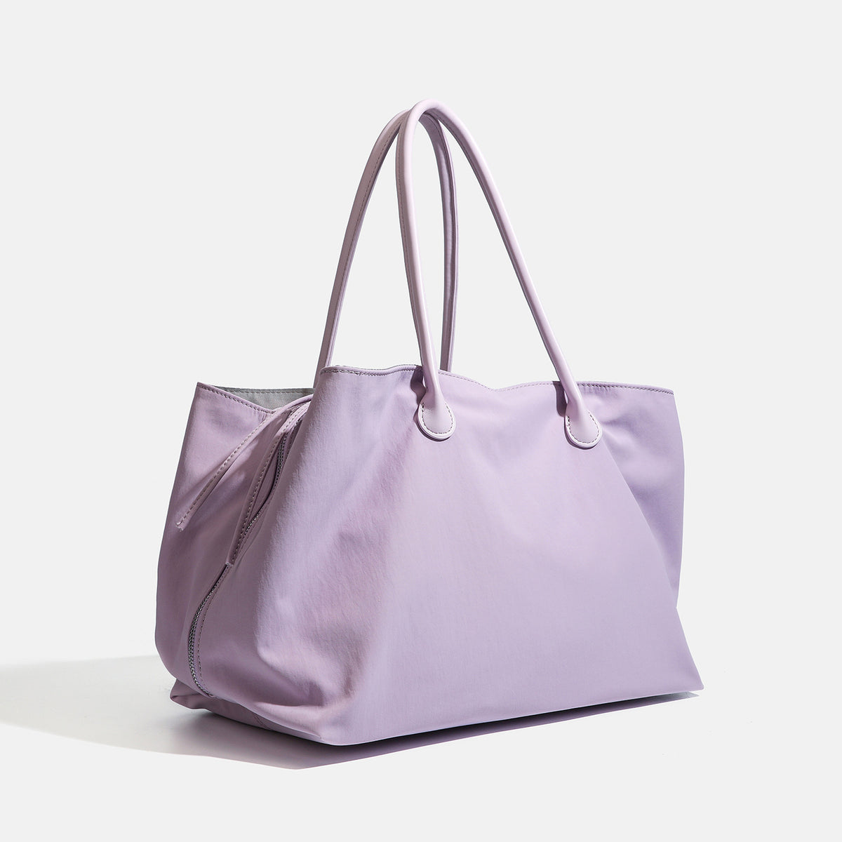Large soft nylon tote bag with long double handles and zippered top in lavender, detail view 2