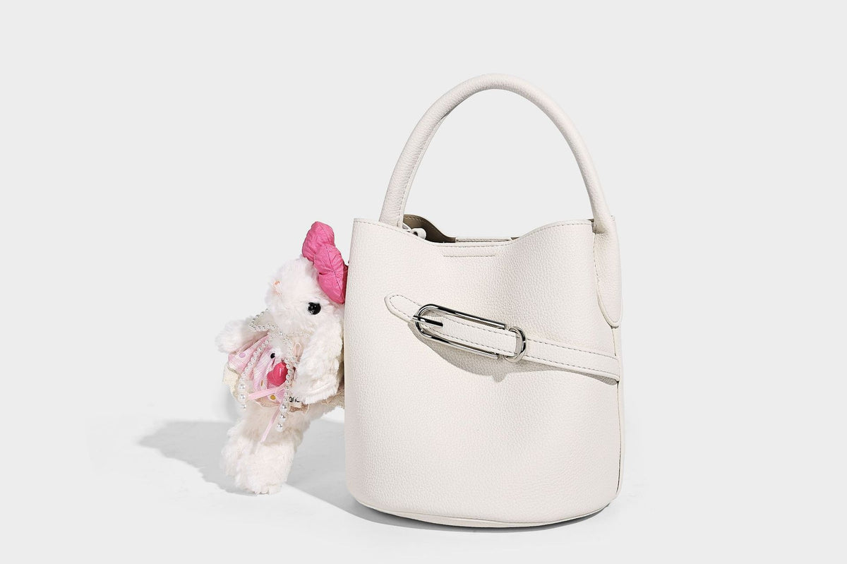 Mini pebbled leather-look bucket bag with front buckle strap, silver-tone hardware, top handle, and detachable shoulder
