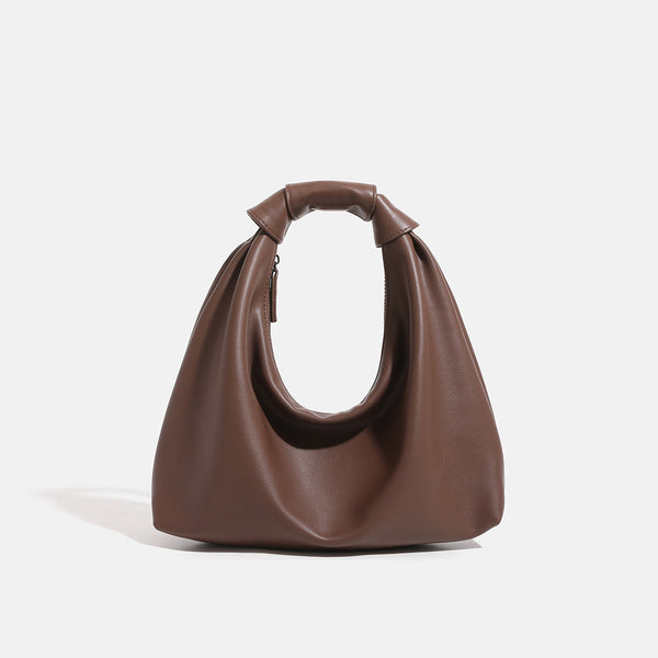 Slouchy leather-look hobo bag with knotted loop handle and top zipper closure, detail view 7