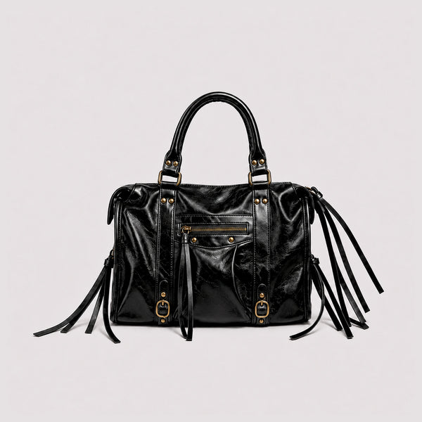 Structured glossy leather-look satchel bag with brass-tone studs, side tassel fringe, dual top handles, and front zip pocket