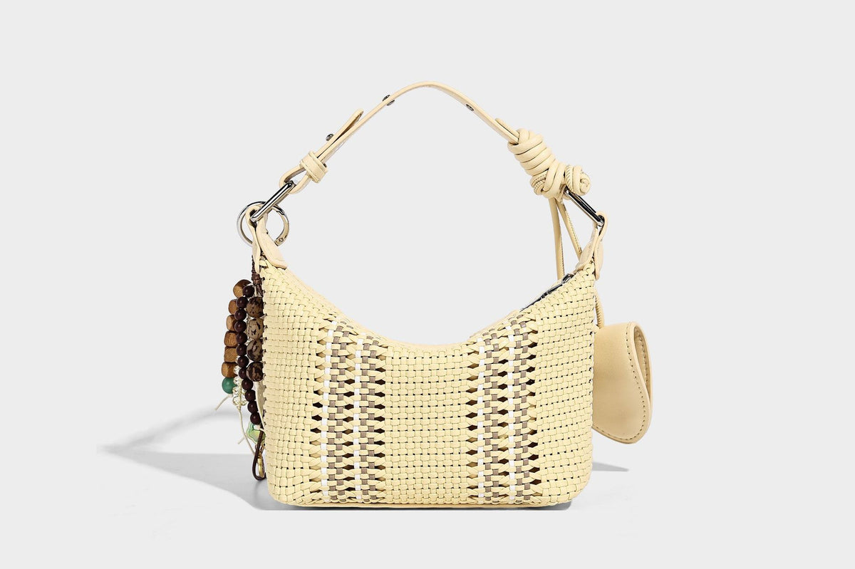 Small woven crescent shoulder bag with leather-look trim, zip closure, silver-tone ring hardware, and beaded tassel charm