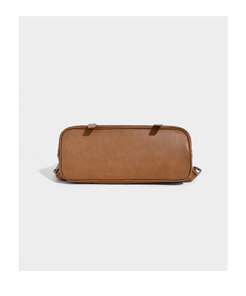 Structured tan leather-look flap backpack handbag with top handle, silver buckle hardware, and fold-over front closure